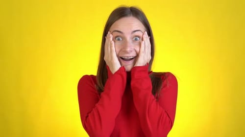 Beautiful Young Woman Posing Isolated on Yellow Background in Studio