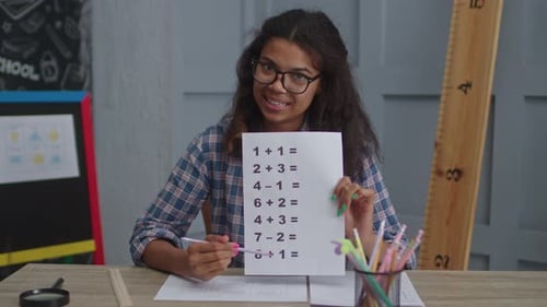 Enthusiastic Woman Explaining Math Problems with a Worksheet