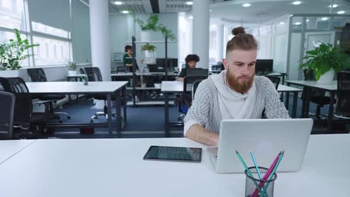 Hipster Employee Working in Open Space Office