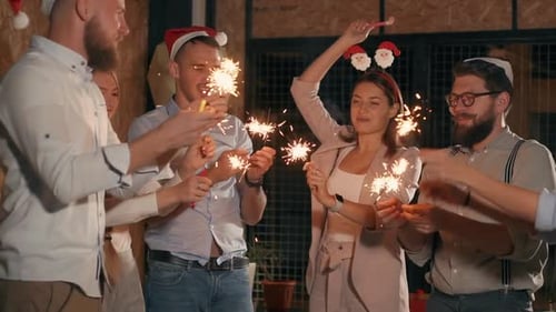 Group Celebrating with Sparklers at Office Party