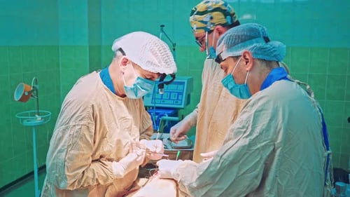 Team of Surgeon Operation on a Patient at Surgery Clinic