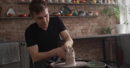Potter Sculpts a Jug on a Potter's Wheel Video From Pottery Workshop Potter Makes Ceramics in Slow