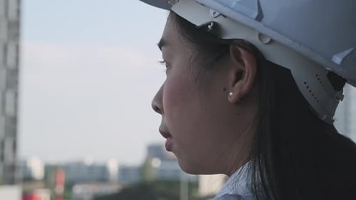 Female construction engineer with a tablet computer at a construction site.