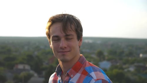 Young Man Posing Outdoors in Plaid Shirt