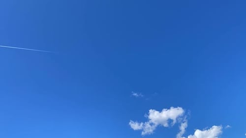 Blue Sky with Clouds and an Airplane
