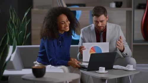 Multiethnic Business Team Video Calling Using Laptop Computer in Office Cafe