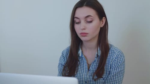 Portrait of Busy Woman Working with Laptop in Office