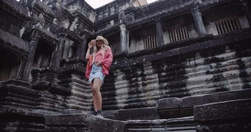 Female Tourist Posing Outside Ruins of an Ancient Temple