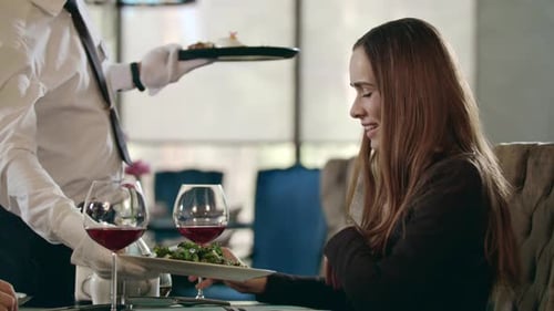 Businesswoman Getting Ordered Food in Restaurant. Waiter Serving Meal