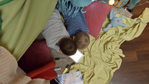 Top View of Kids Playing on Tablet