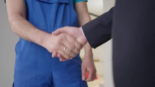 Man in Overalls Handshake Agreement
