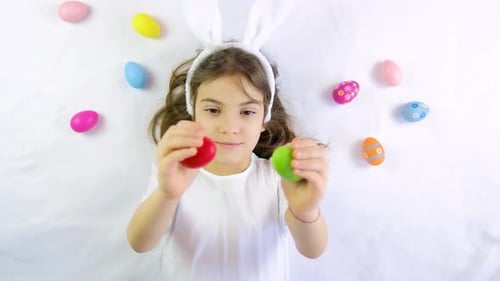 Girl with Bunny Ears Holding Easter Eggs