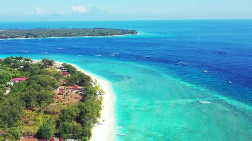Idyllic vacation location of tropical island with white sandy beach washed by blue turquoise sea wat