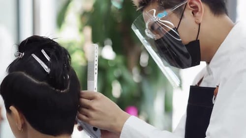 Happy small business owner at a hairdressing studio during COVID-19.
