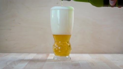 Golden Beer Pouring into a Glass, Overflows