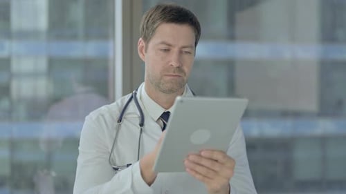 Doctor Scrolling on Tablet, Using Internet