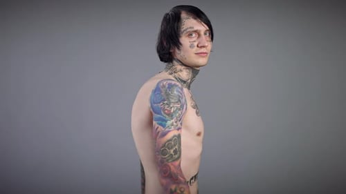 Tattooed Shirtless Man Looking at Camera
