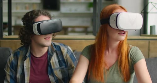 Couple Experiencing Virtual Reality with VR Headsets