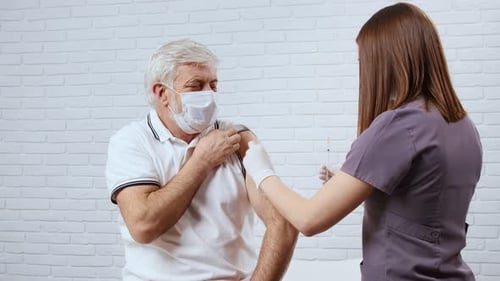 Adult Male Receiving Injection in Upper Arm