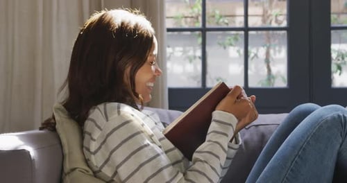 Woman Reading Book in Cozy Home Setting