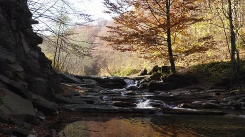 Rocky Waterfall Stream Flows Through Autumn Forest