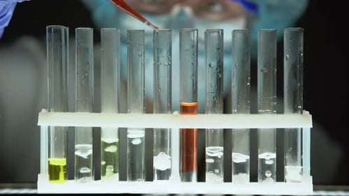 Lab Assistant Adding Red Liquid in Test Tube, Conducting Secret Science Research