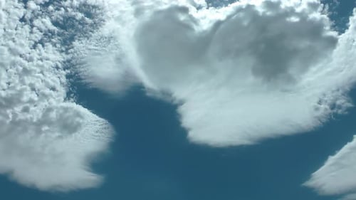 White Clouds Moving Across Vivid Blue Sky