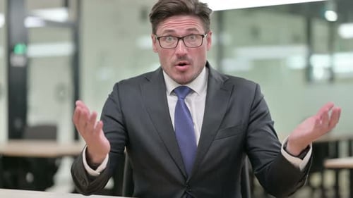 Man Reacts With Shock in Modern Office