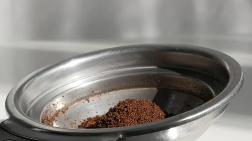 Espresso machine holder filled with coffee 4K footage