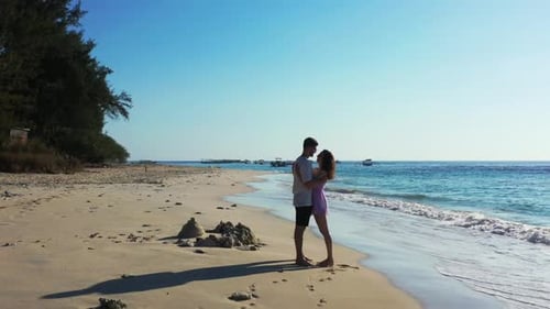 Boy and girl happy together on paradise shore beach wildlife by blue sea with white sand background