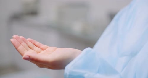 Doctor Disinfecting Hands with Bactericidal Gel