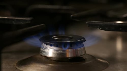 Gas Stove Ignites with Blue Flame Close Up