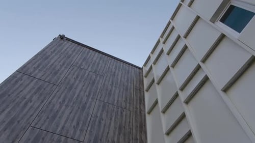 Elegant Building with Textured Facade Under Clear Blue Sky
