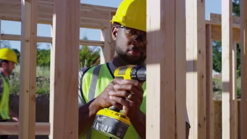 Construction worker using drill