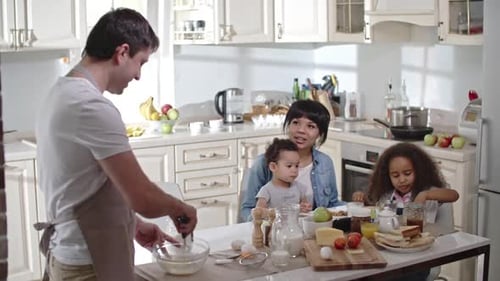 Family Cooking Together in Bright Kitchen