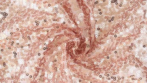 Tissu rose doré à paillettes