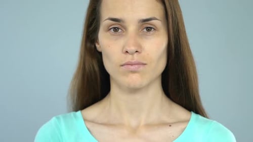 Woman Holds Stop Sign to Camera