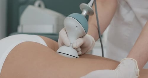 Medical Professional Using Handheld Device on Person's Leg