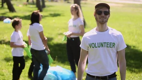 Portrait of Confident Man Family Recycle Plastic Bottle Activist Wear Gloves Smiling in Park