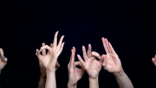 Multiple Hands Making 'Ok' Gesture on Black Background