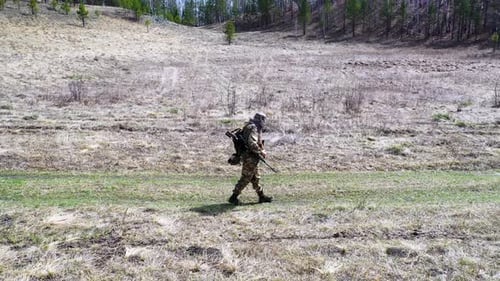 Lonely Tired Soldier Walking Along the Forest Road