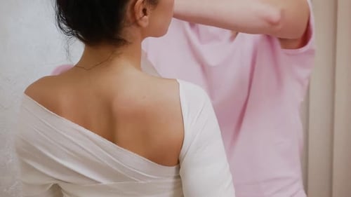 Medical Professional Applying Bandage Wrap to Woman