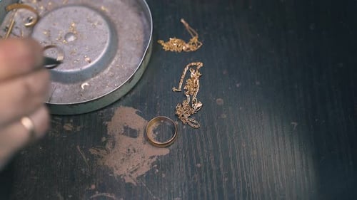 Jeweler Sorting Precious Gold Scrap Pieces