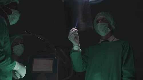 Medical Team Reviews X-Ray in Operating Room