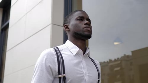 Portrait of businessman walking in city