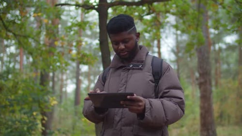 African Hiker Man Using Gps App on Digital Tablet