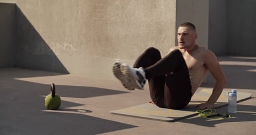 Sportsman Doing Abs Exercise on Sports Ground