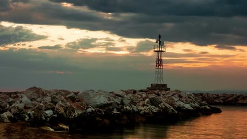Lighthouse on a Rocky Seashore During Sunset, Timelpse