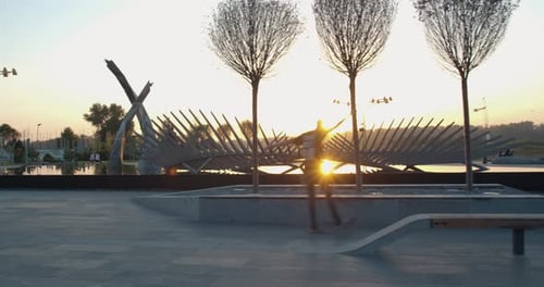Skater Boys Are Doing Tricks at the Park, Early Morning Sky in the Background