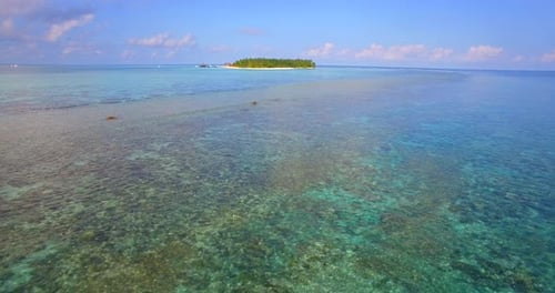 Aerial drone view of a scenic tropical island in the Maldives.
